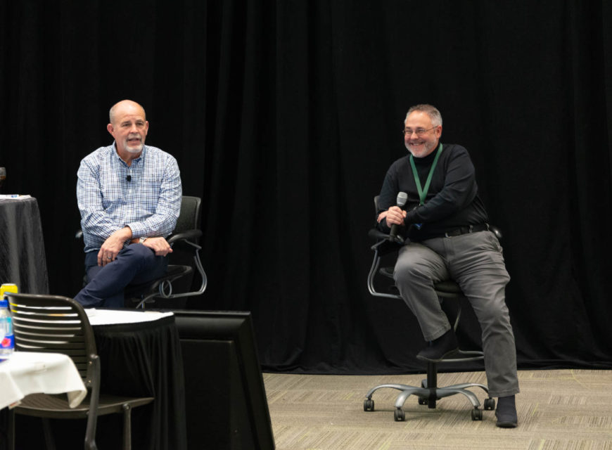 CU*Answers CEO Randy Karnes (left) is joined on stage by CU*Answers OpsEngine Business Development Manager Jeff Miller.