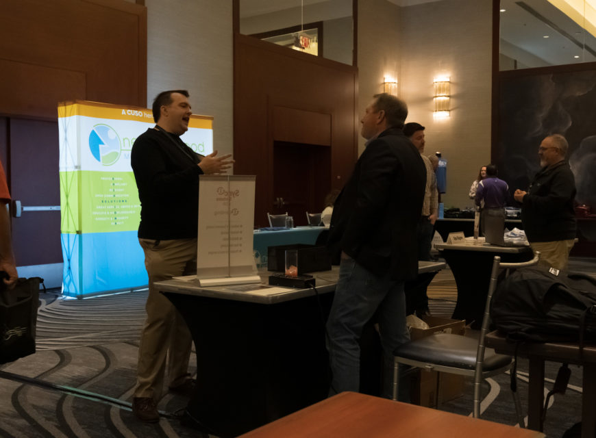 1st Street Credit Union President/CEO Arthur Hart engages in conversation with a representative from Sync1.