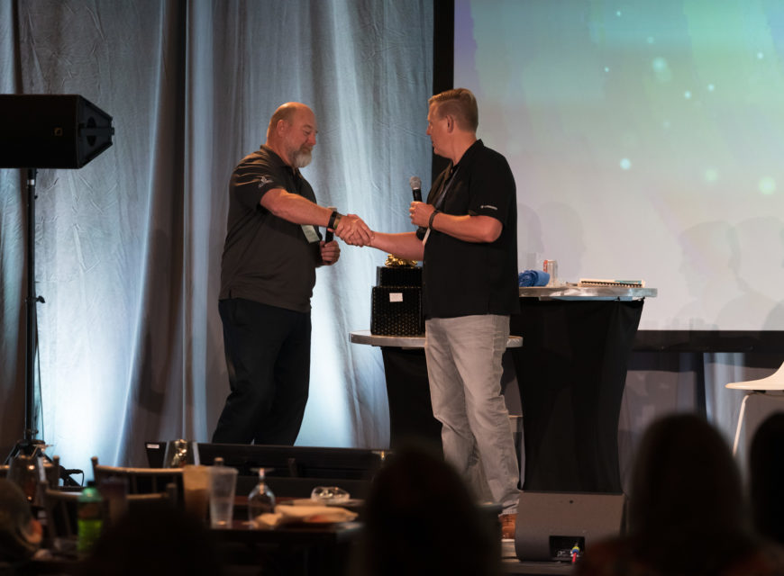 CU*Answers President/COO Geoff Johnson congratulates 1st Community FCU CEO Bill Nikolauk on winning the 2021 Spirit of CU*Answers award. 
