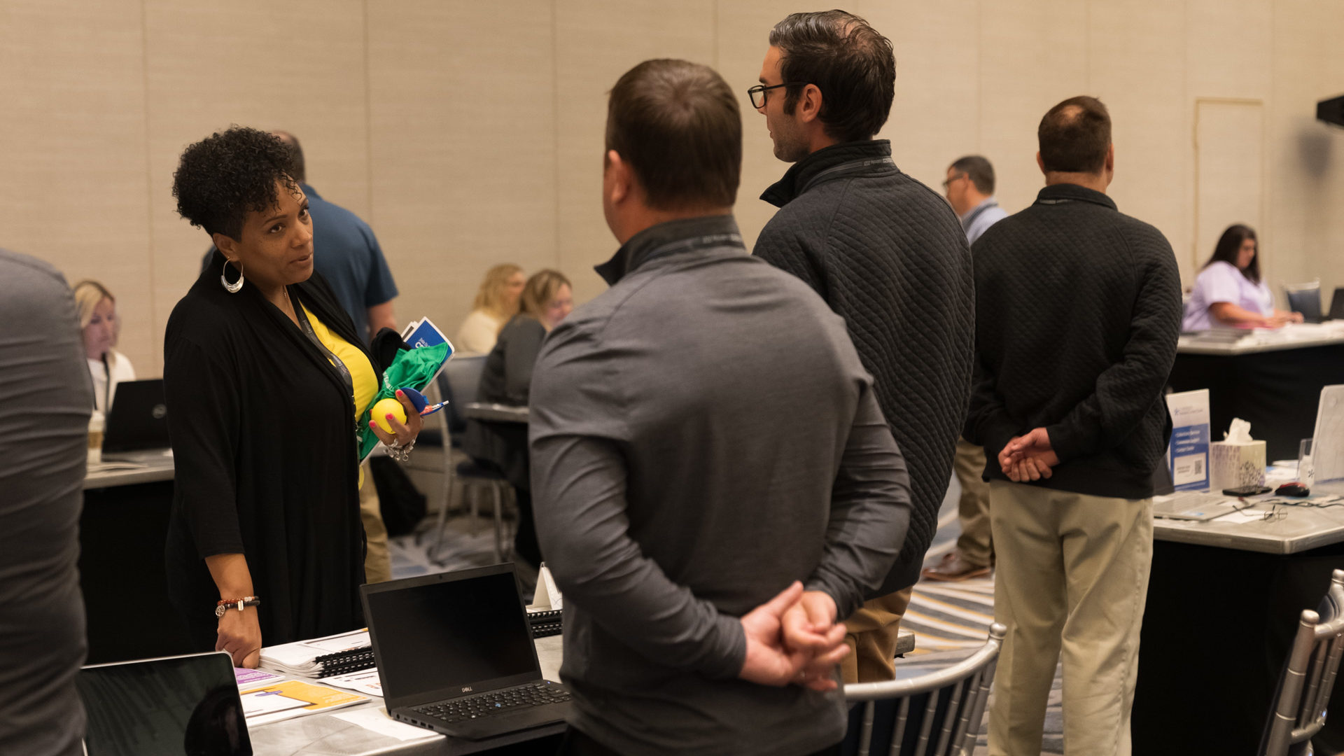 Attendees speak with vendors. 